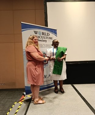 Dr. Wendy Seale, former WAS President, hands the mantle to Dr. Foluke Areola, the incoming President of WAS in Singapore.